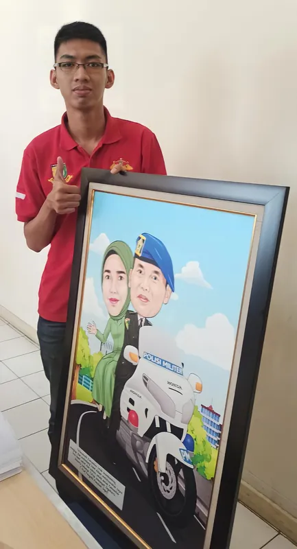 Seorang pria muda memegang karikatur berbingkai bertema kendaraan dinas.